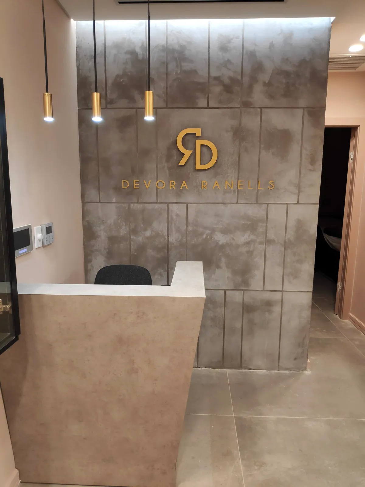 The reception desk with the RD logo on the gray stone wall